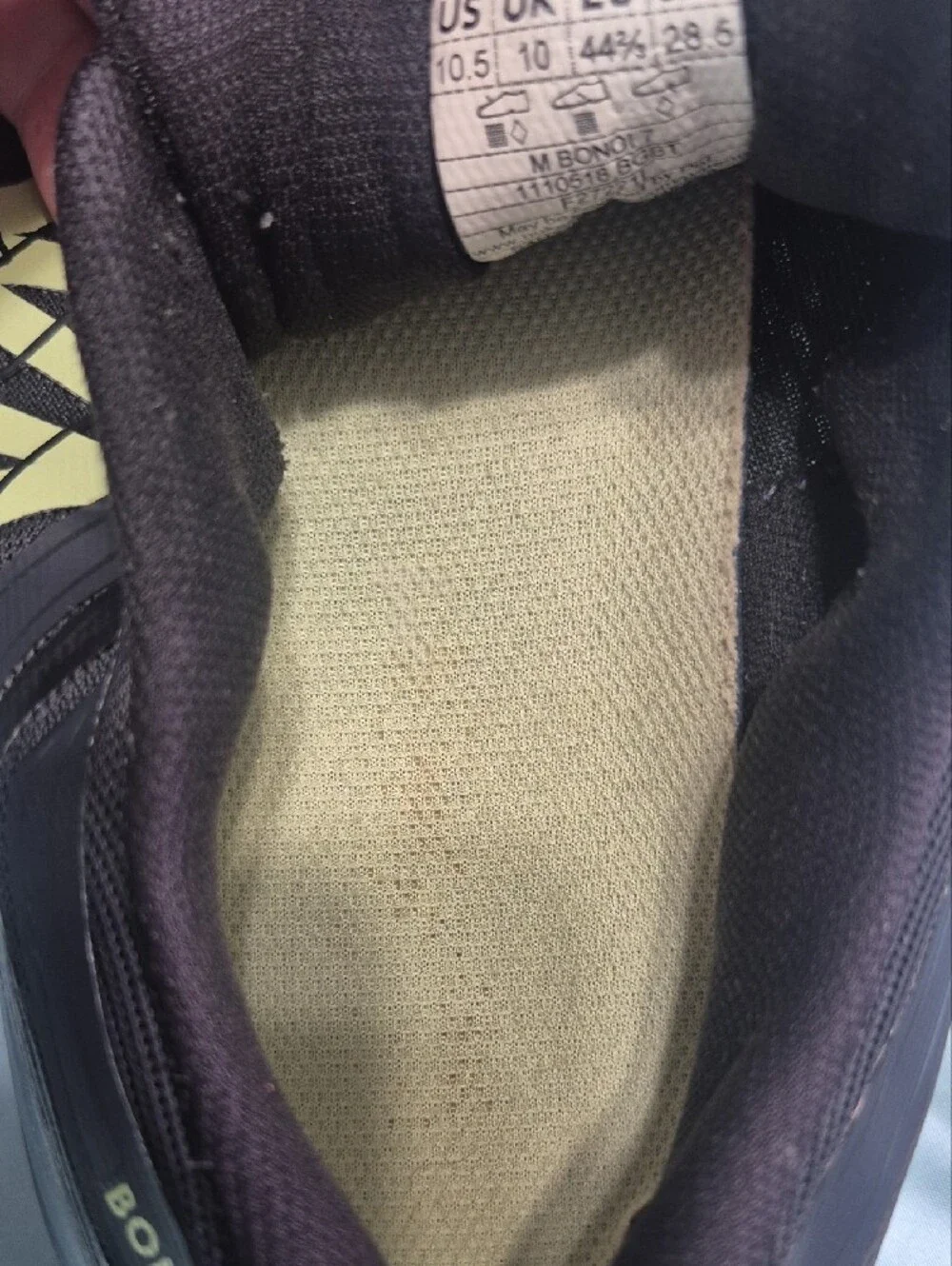 Hoka black running shoes with pale yellow logo